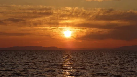 Golden Sunset Over Calm Ocean Waves With Orange Sky Stock Footage 332682520