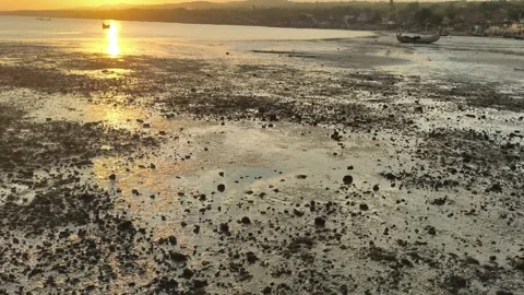 Golden Sunset over Low Tide Tropical Beach and Coastal Village Video stock 340465064