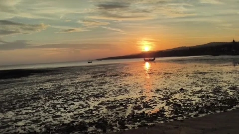 Golden Sunset over Low Tide Tropical Beach with Traditional Boats Stock Footage 340465170