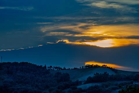 Golden sunset over Marche Romagna hills with dramatic clouds Stock Photos