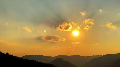 Golden Sunset Over Mountain Range with Radiant Sky and Clouds Vídeo Stock 335984776