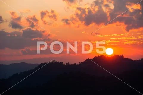 Golden sunset over the mountain top. Stock Photos