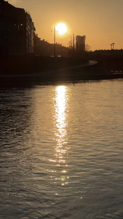 Golden sunset over Neris River reflecting warm light in Vilnius cityscape Stock Footage 306959759