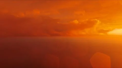 Golden sunset over ocean with dramatic clouds aerial view Stock Photos
