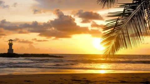 Golden sunset over ocean waves washing sand of tropical beach. Wanderlust Stock-Footage 197544361