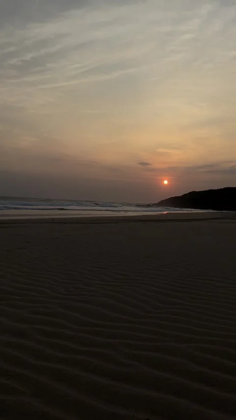Golden Sunset Over Ocean Waves on Sandy Beach, Low Angle Vertical Shot Stock Footage 324772415