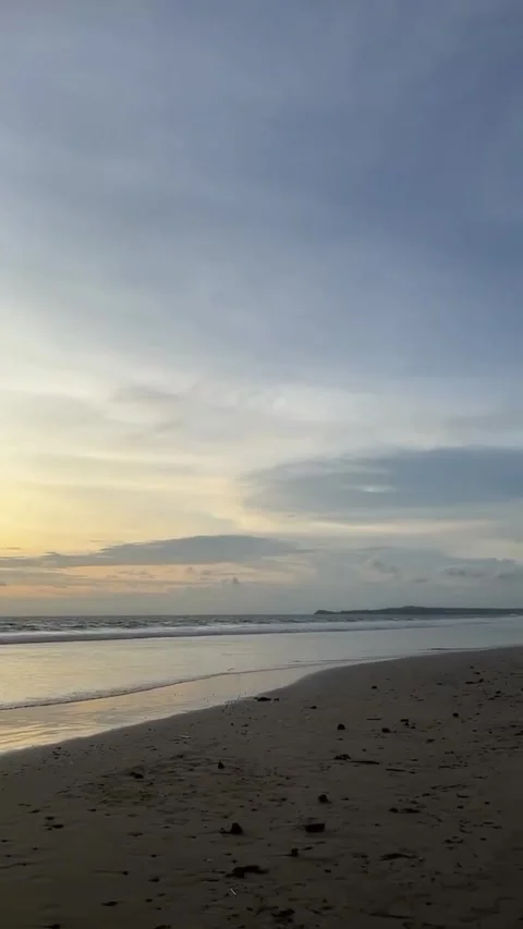 Golden Sunset Over Sandy Beach and Ocean Waves Stock Footage 341317295