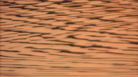 Golden sunset red river rippling water wave seamless texture background pattern Stock Footage 237471627