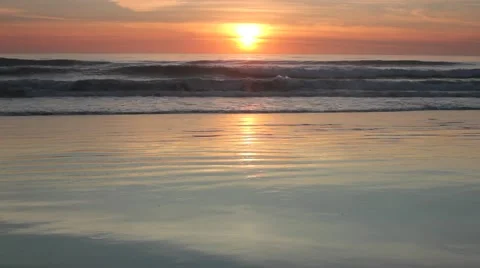 Golden Sunset reflecting on a Beach 2 min clip Stock Footage