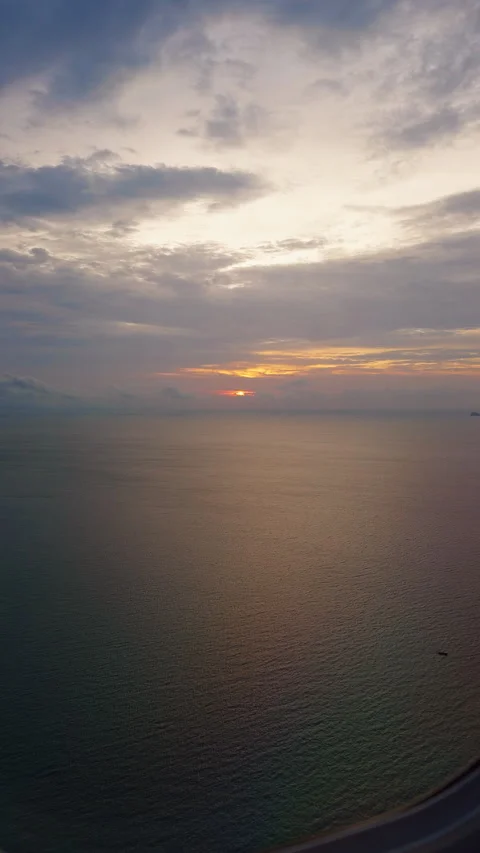 Golden Sunset Reflection Across Calm Ocean Beneath Layered Clouds, Peaceful Even Video stock 337151517