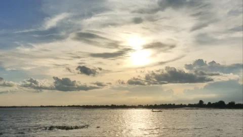 Golden Sunset Reflection on Lake Water with Distant Small Boat Stock Footage 342952708