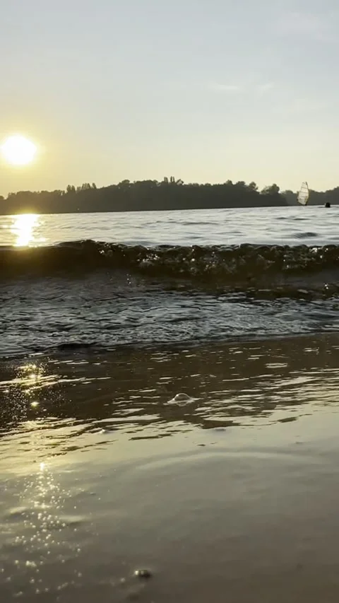 Golden Sunset Reflection on Lake Waves Gently Reaching Shore in Slow Motion Stock Footage 341596943