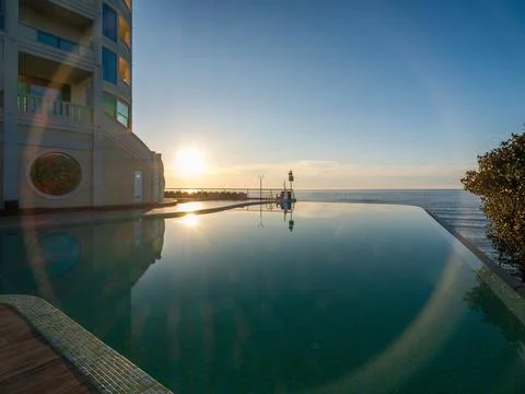 Golden Sunset Reflection in Luxury Infinity Pool. Stock Photos