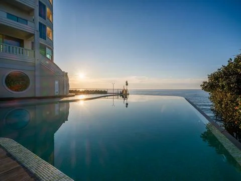 Golden Sunset Reflection in Luxury Infinity Pool. Stock Photos