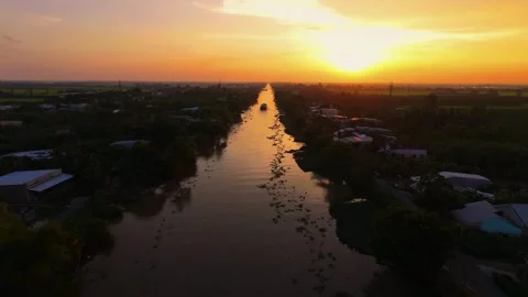Golden Sunset Reflection Over Calm Straight Canal in Southwestern Vietnam Stock Footage 343606708