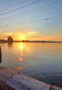 Golden Sunset Reflection Over Calm Sea Stock Photos