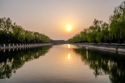 Golden sunset reflection over long canal in Beijing Stock Photos