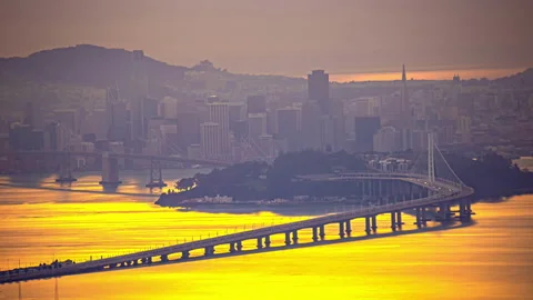 Golden sunset reflection off San Francisco Bay with car traffic on Bay Stock Footage 265138200