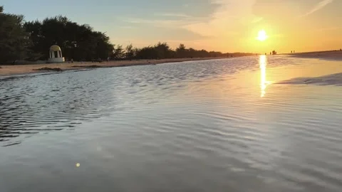 Golden Sunset Reflection on Tropical Beach with Coastal Silhouettes Stock Footage 340216035