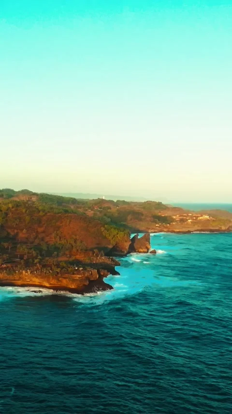 Golden sunset reflects across rolling ocean waves near the Ngerenean coastl.. Stock Footage 341542969