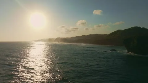 Golden sunset reflects across rolling ocean waves near the Ngerenean coastl.. Stock Footage 341544419