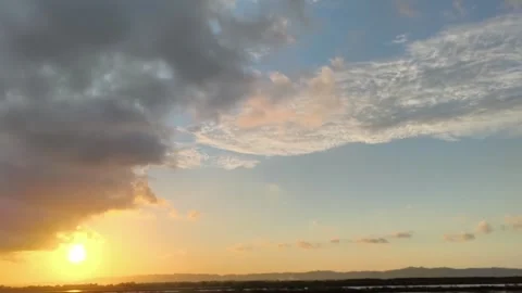 Golden Sunset Sky with Clouds over Distant Mountains at Dusk Stock Footage 340465216