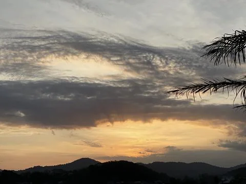 Golden Sunset Sky With Dramatic Cloud Formations Over Jelebu Mountains Stock Photos