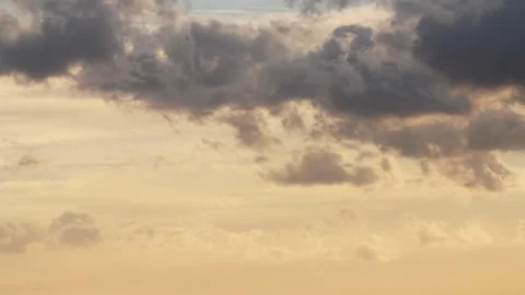 Golden sunset sky with dramatic moving clouds over the desert landscape of Wadi Stock Footage 336199137