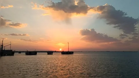 Golden Sunset Timelapse over Sea with Clouds and Industrial Pier Stock Footage 346642844
