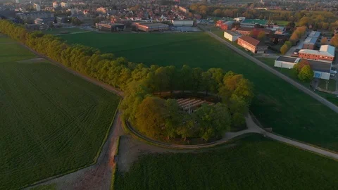 Golden sunset on war monument surrounded with trees beautiful idyllic Aerial Stock Footage 123111698