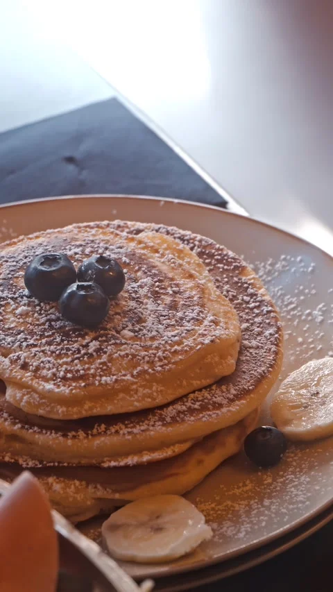 Golden Syrup Pouring Over Stack of Pancakes at Breakfast Stock Footage 334604137