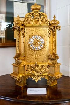 Golden table clock in Cherepanovs Technical Museum Stock Photos