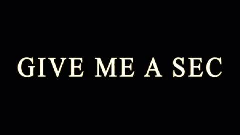 Golden text GIVE ME A SEC repeating on black background with subtle cinemat.. Stock Footage 344035503