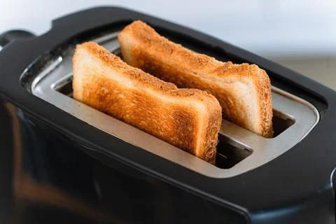Golden Toasted Bread Slices Inside Electric Toaster Stock-Fotos