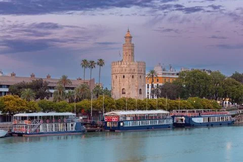 The golden tower of Torre del Oro in night illumination at sunset. Stock Photos