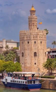 The golden tower of Torre del Oro on a sunny day. Seville. Stock Photos
