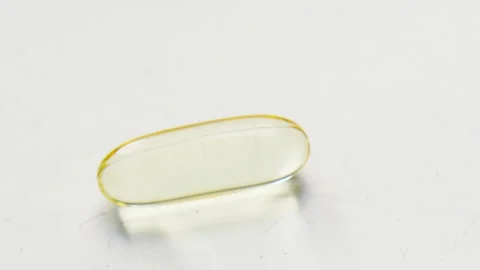 A Golden, Translucent Omega-3 Cod Fish Liver Oil Supplement Tablet 스톡 동영상 328680342