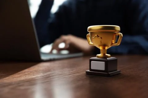 Golden trophy puts on table in front of businessman Stock Photos