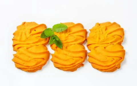 Golden twisted pastry with mint leaf garnish Stock Photos