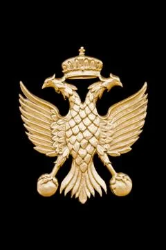 Golden two-headed eagle in black background. Stock Photos