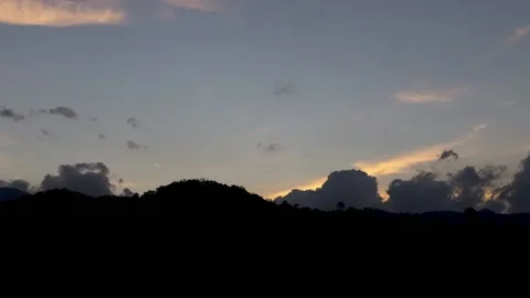 A golden view of the sun setting behind the hills. Stock Footage 212264011