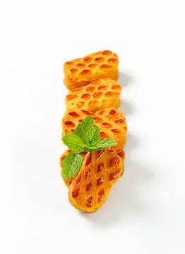 Golden waffle cone with mint leaf garnish Stock Photos