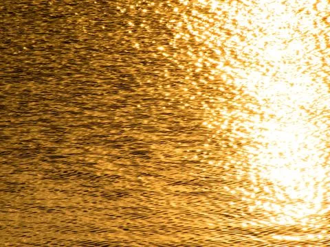 Golden wavelets on the surface of river Stock Photos