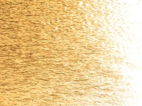 Golden wavelets on the surface of water Stock Photos