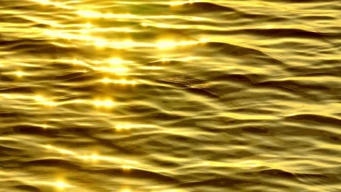 Golden waves reflecting sunlight in a tranquil ocean. Stock Footage 308508996