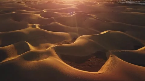 Golden waves of sand under a radiant sunset sky Stock Footage 307643140