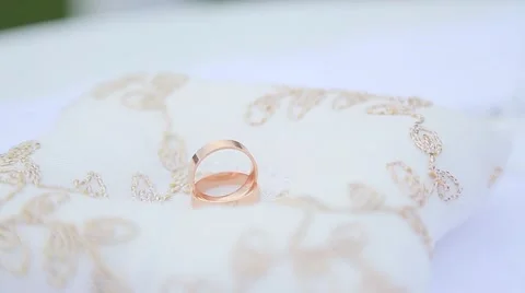 Golden wedding rings on white background Stock Footage 64862802