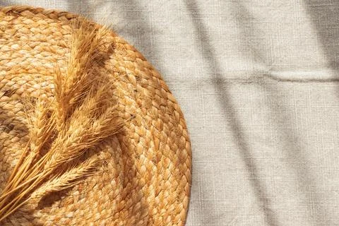 Golden wheat ears resting on rustic wicker mat Stock Photos