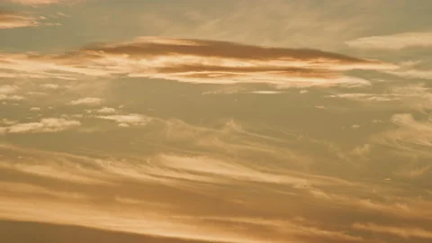 Golden whispy clouds in the sky at sunset Stock Footage 153145880