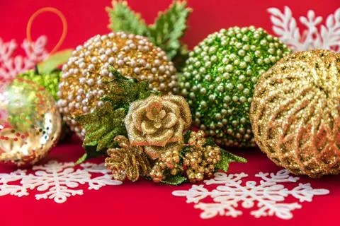 Golden, white and green Christmas decoration on red background Stock Photos